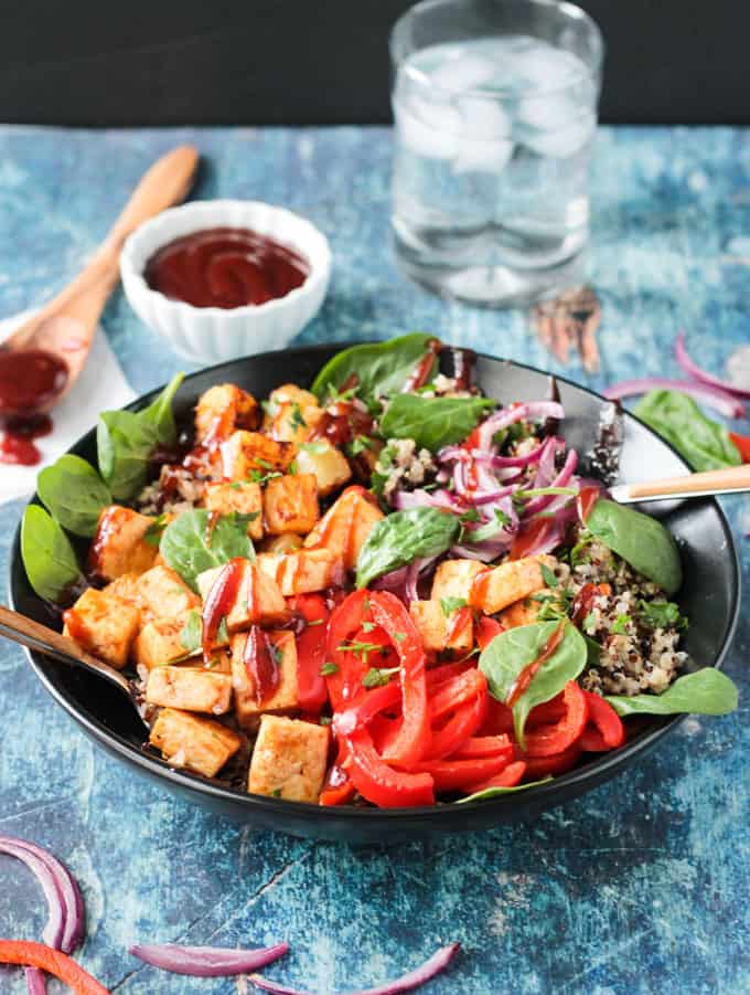 Front view of a tofu dinner bowl drizzled with bbq sauce.