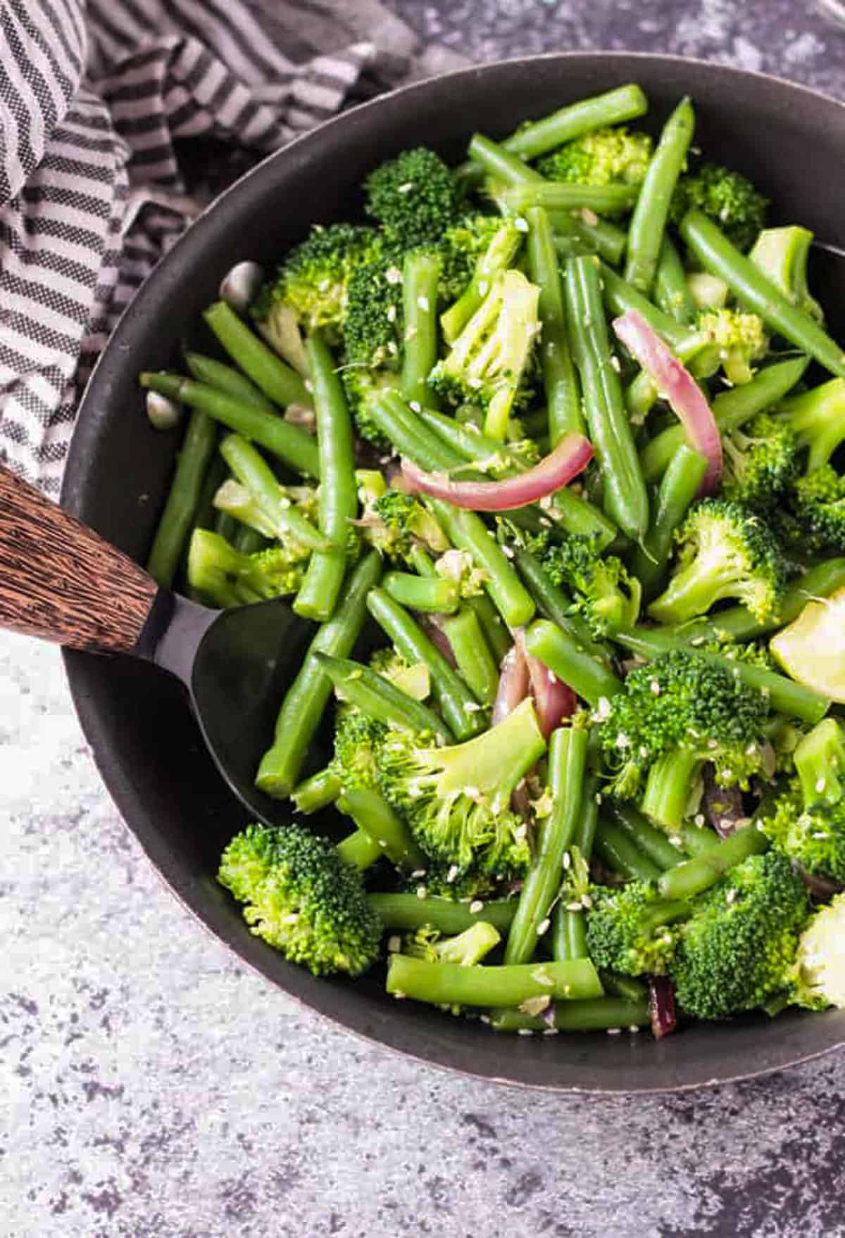 Easy Green Bean Broccoli Stir Fry. An easy weeknight vegetable side dish that takes less than 30 minutes. Just a few ingredients are needed, but it brings lots of flavor and nutrients. Serve it as a side or over pasta or rice. Close up overhead view of a vegetable stir fry.