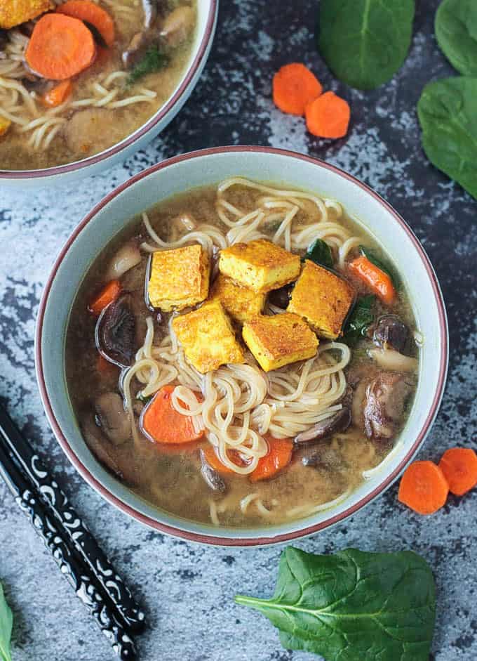 Bowl of Mushroom Ramen Soup topped with small bite size squares of crispy tofu.