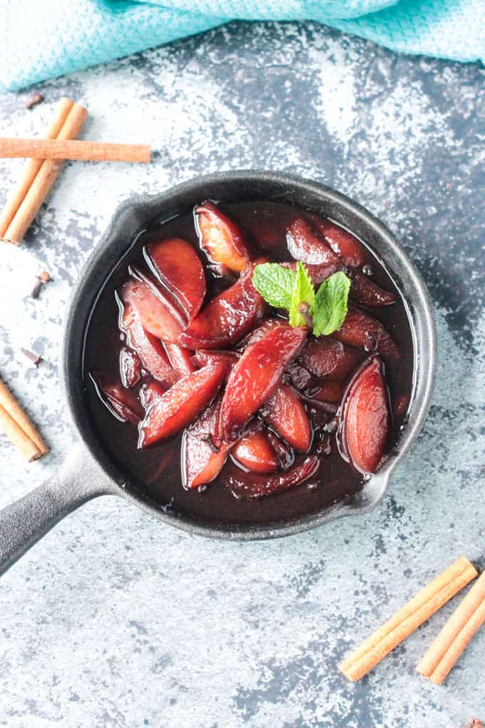 Poached nectarines in a cast iron skillet.