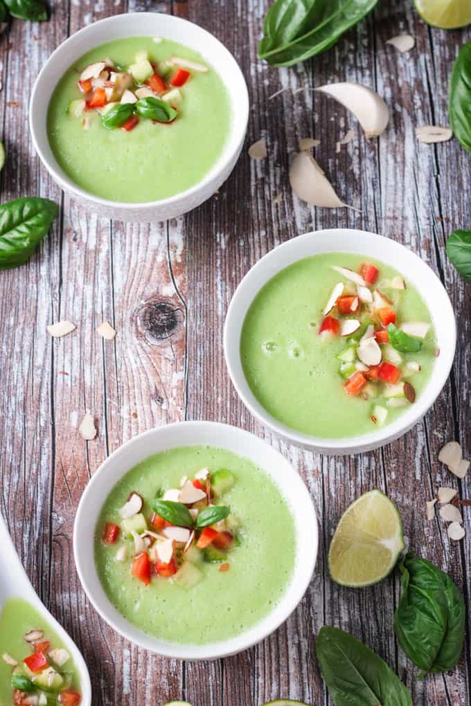 Overhead view of three bowls of cold cucumber soup.