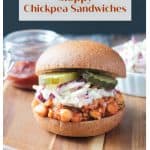 BBQ Chickpea Sandwich topped with creamy coleslaw and pickles on a whole wheat bun.