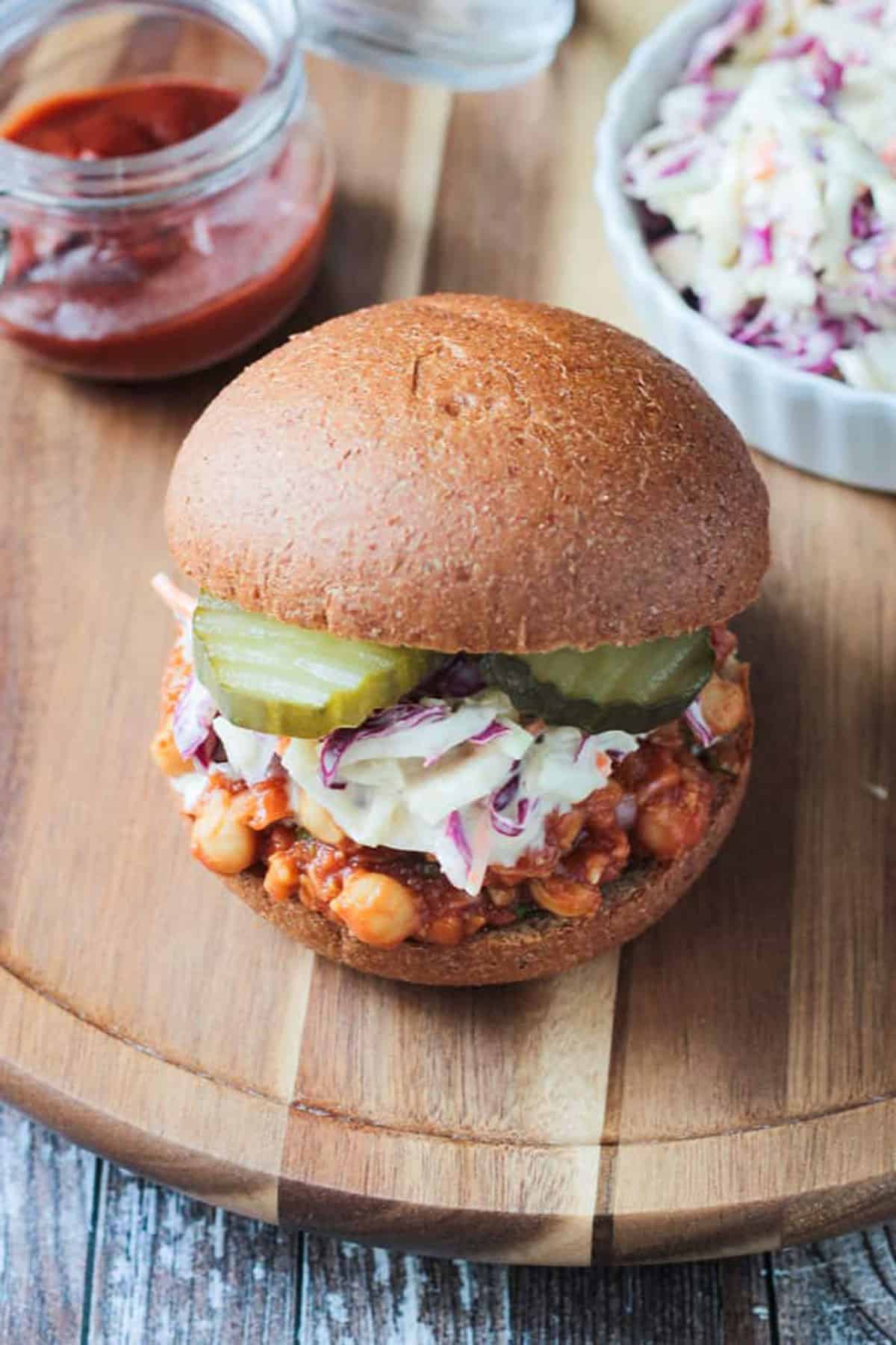 Overhead view of chickpeas in bbq sauce on a bun.