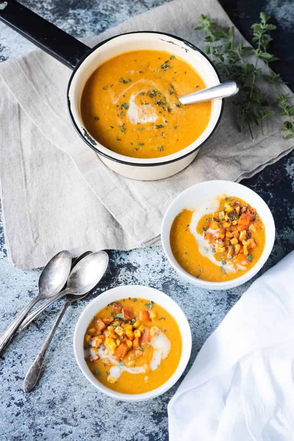 Overhead view of two bowls of vegan butternut squash soup.