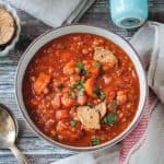 Bowl of Hungarian Red Lentil Soup topped with a few broken crackers.