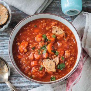 Bowl of Hungarian Red Lentil Soup topped with a few broken crackers.