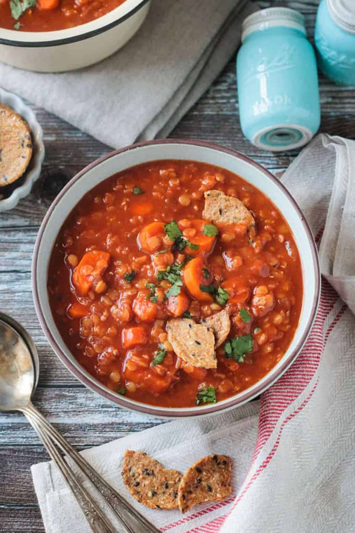 Bowl of Hungarian Red Lentil Soup topped with a few broken crackers.