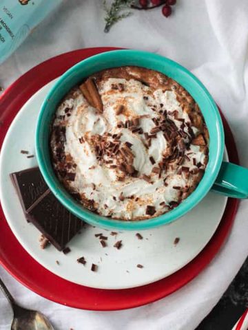 Bom Bom Brands Nilli Vanilli bottle near a mug of spiked hot cocoa.