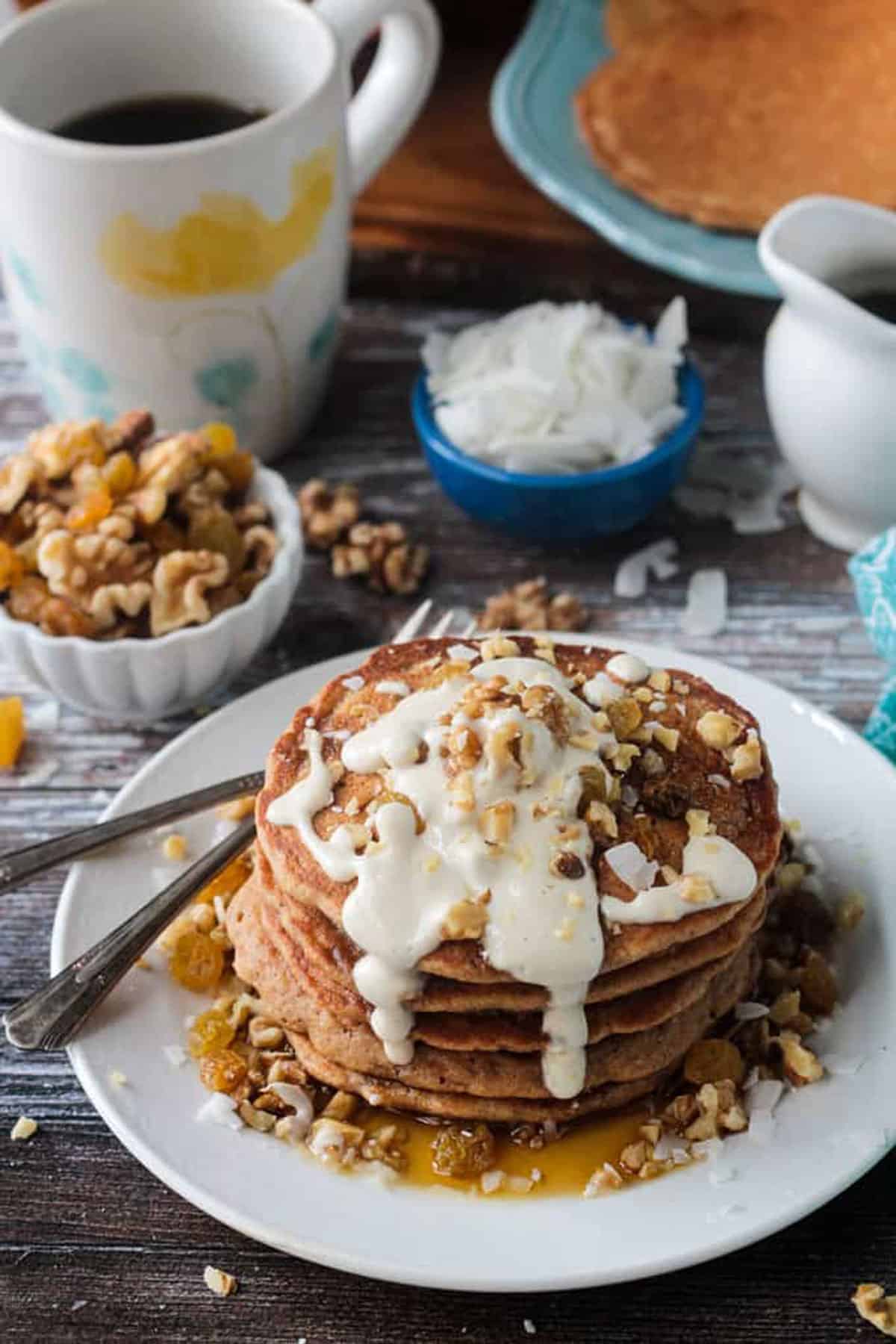 White icing on top of a stack of pancakes.