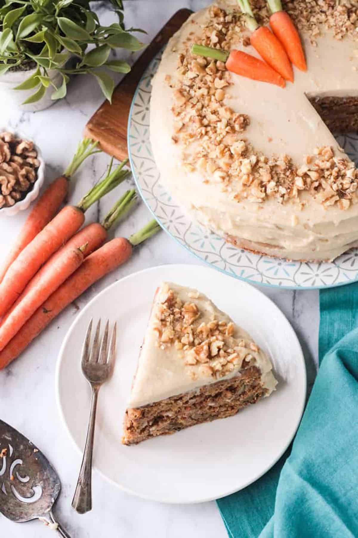 One slice on a white plate with a fork. Rest of the cake behind.