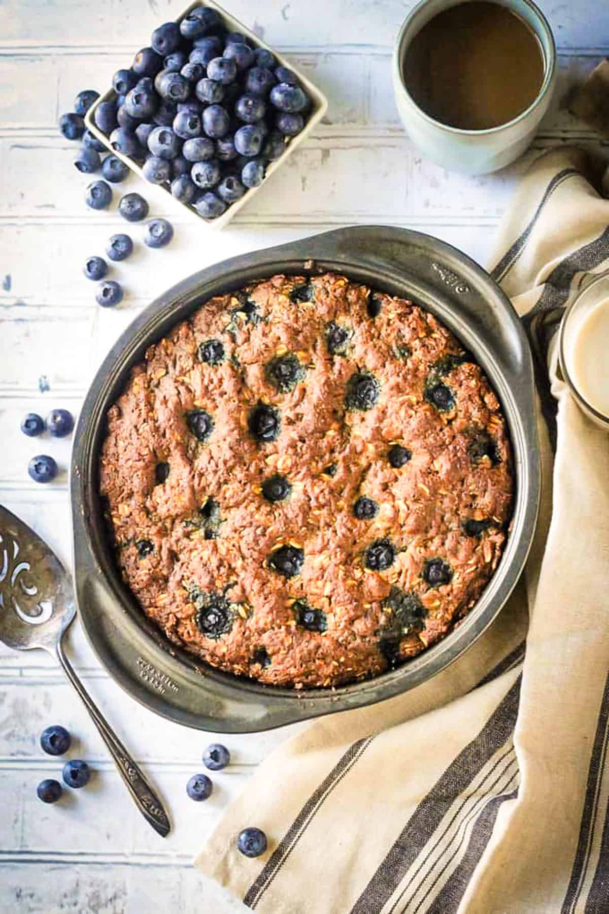 Blueberry breakfast cake baked in a round cake pan.