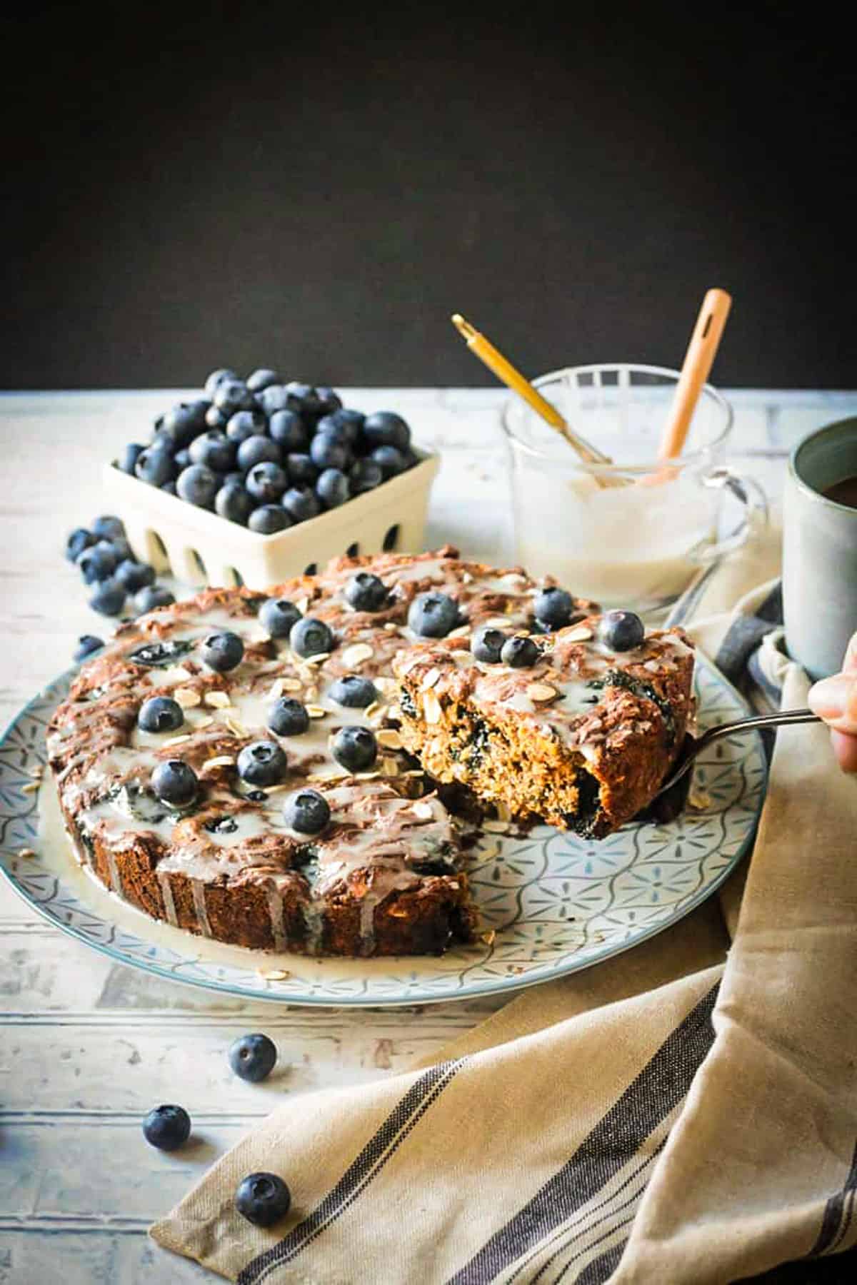 A spatula lifting a slice of cake out of the pan.