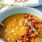 Spoon in a bowl of split pea soup.