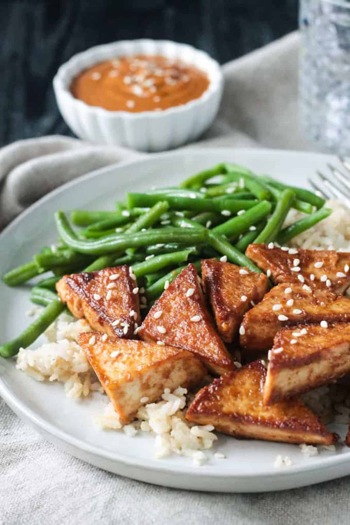 Finished dish with green beans on a white plate.