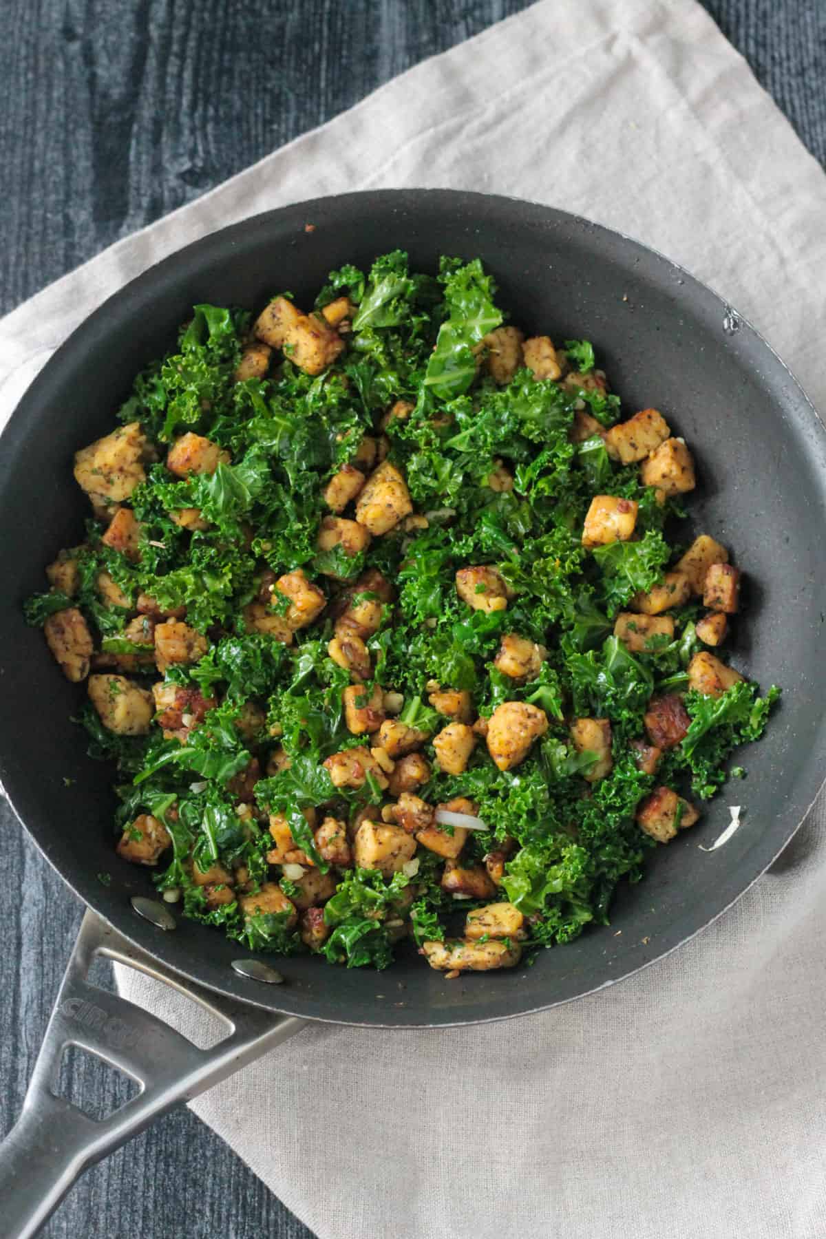 Sautéed kale and tempeh in a skillet.