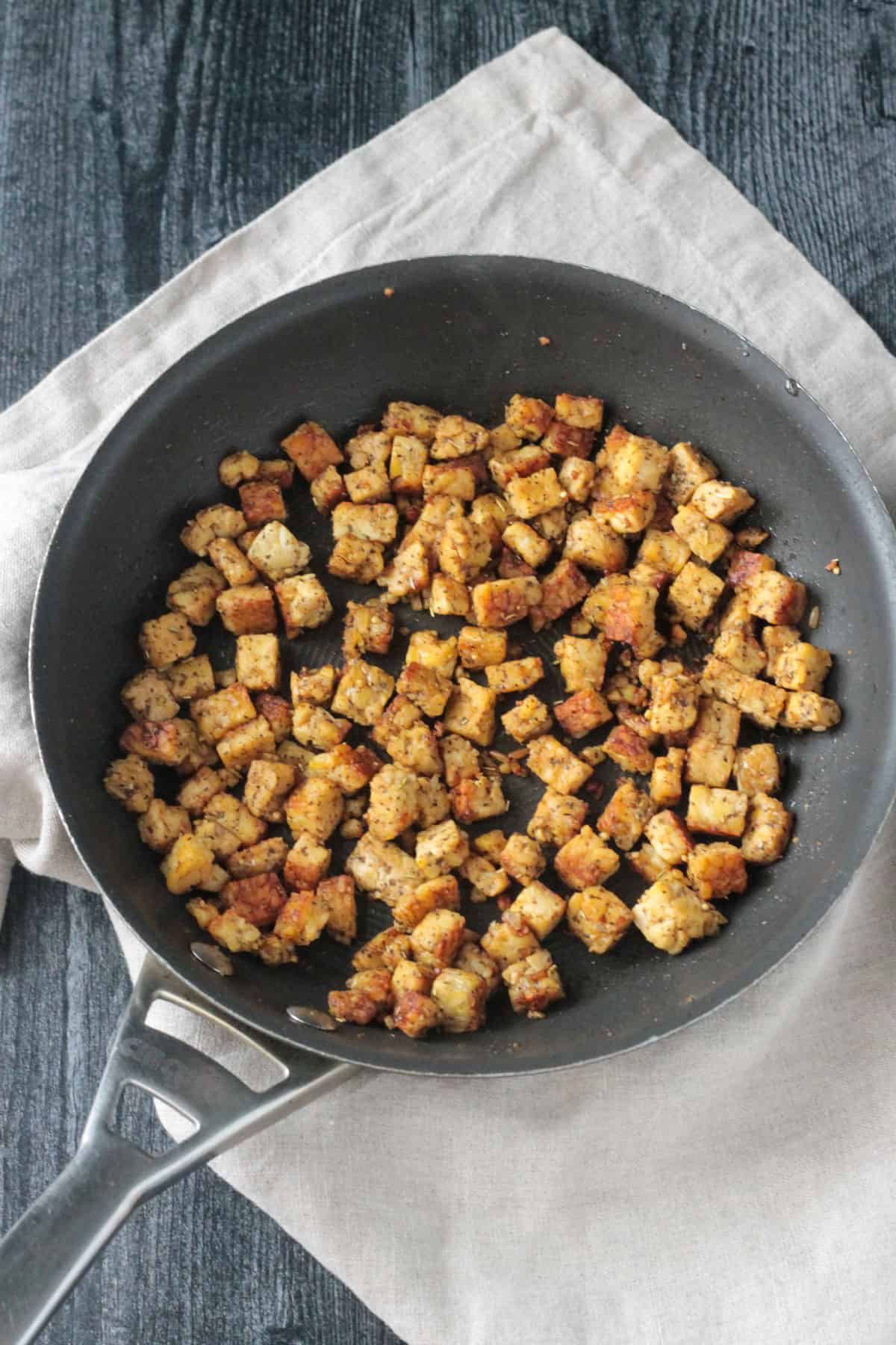 Chopped tempeh in a skillet.