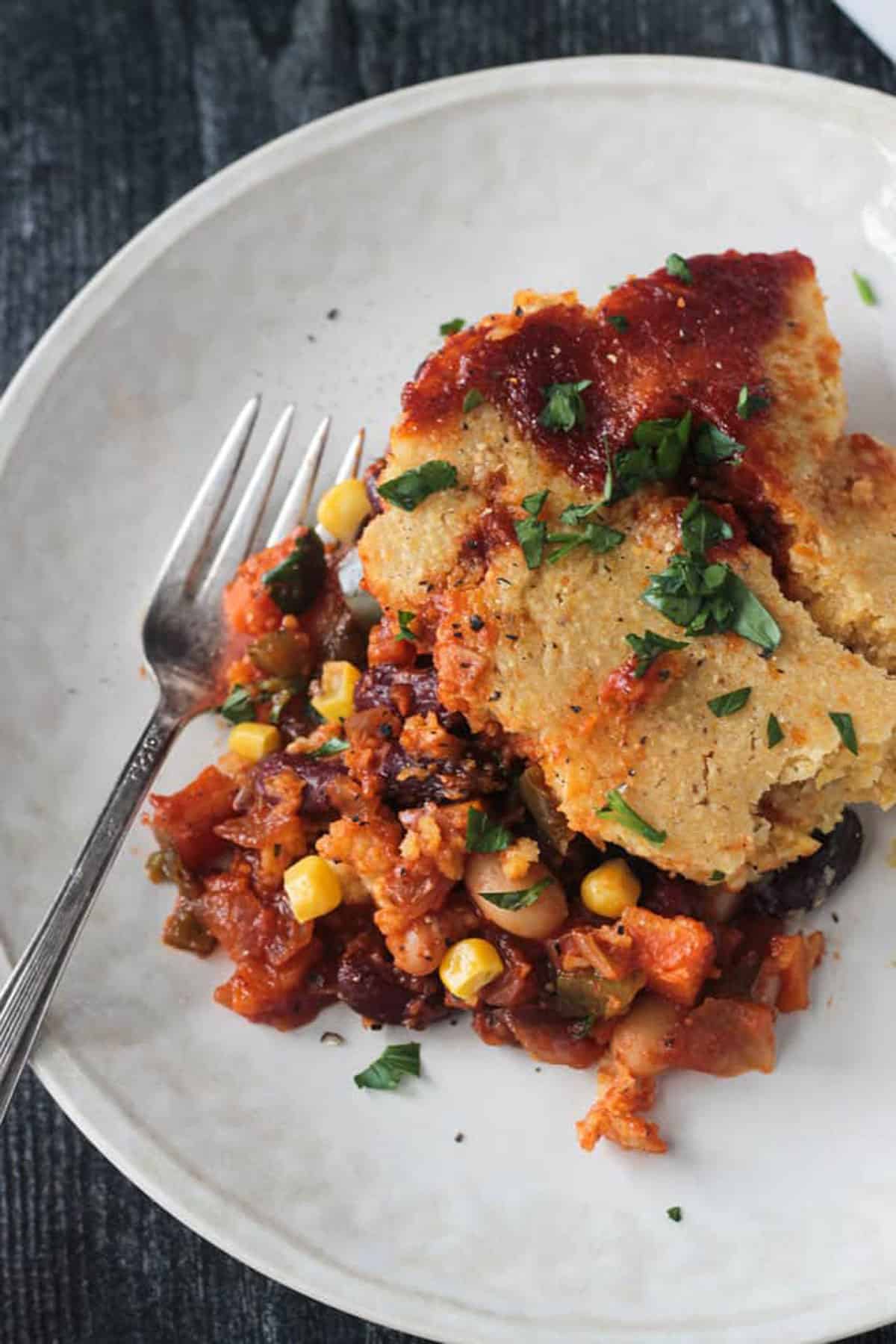 Close up of the saucy beans and cornbread crust.