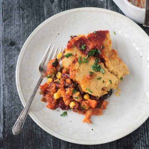 Sloppy Joe Casserole with Cornbread Crust on a white plate with fork.