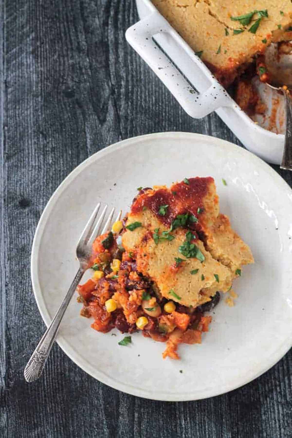 Sloppy Joe Cornbread Casserole on a white plate with fork.