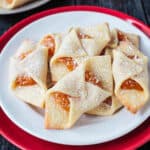 A pile of vegan apricot kolaczki on a plate.