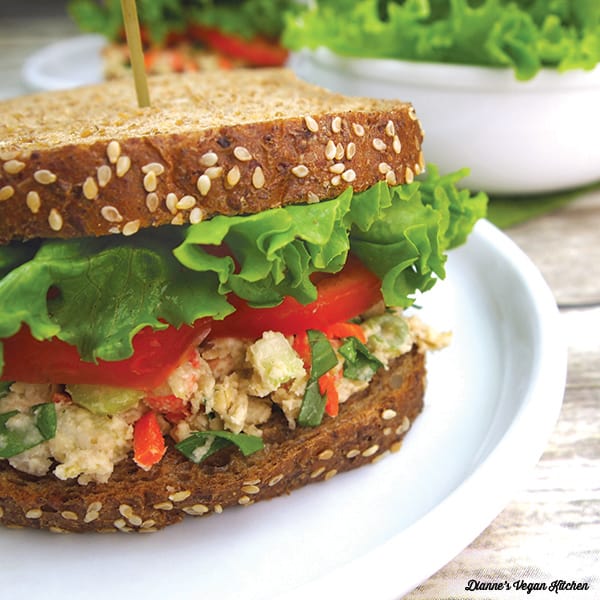 curly lettuce leaves on a sandwich with tomato and chickpea salad