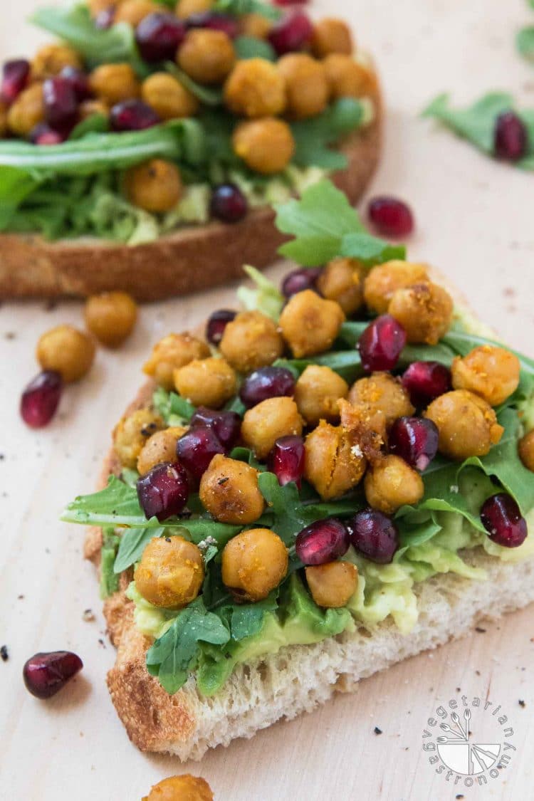 chickpea and pomegranate seeds on avocado toast