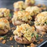 Close up of the artichoke filling in stuffed mushrooms.