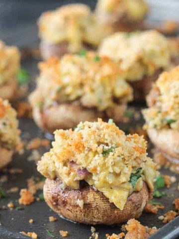 Close up of the artichoke filling in stuffed mushrooms.