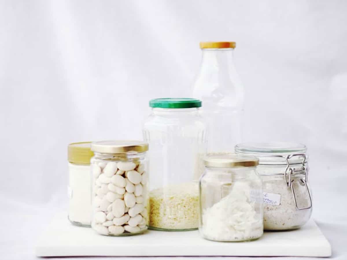 Collection of glass storage jars filled with pantry staples.