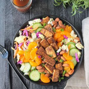 Salad w/ green and red cabbage, cucumbers, mandarin oranges, carrots, and baked tofu.