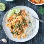 Vegetable curry on a plate with a fork.