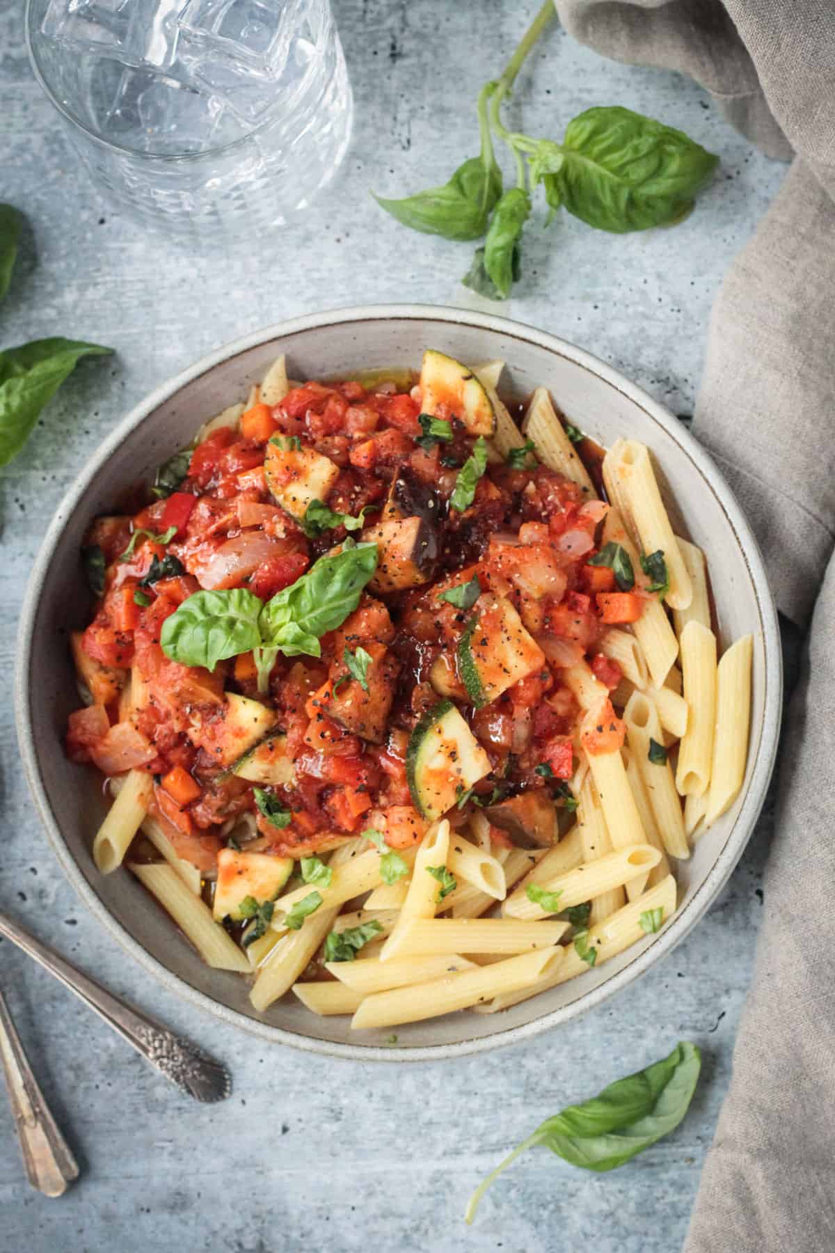 penne topped with marinara with fresh basil