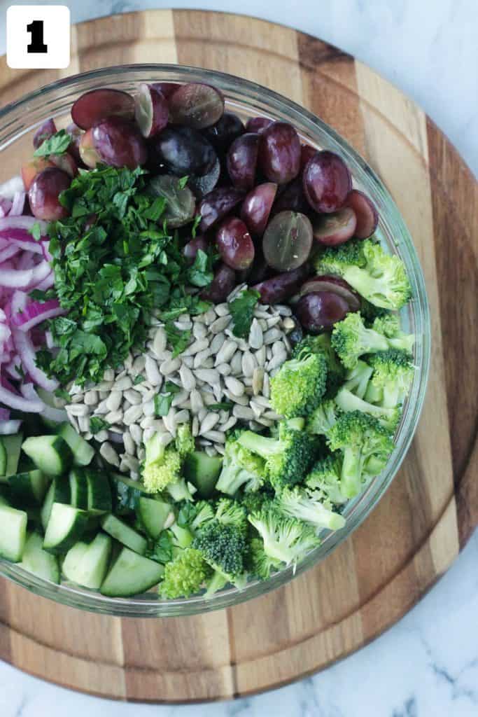 Chopped broccoli, grapes, cucumber, red onion, parsley, and sunflower seeds.