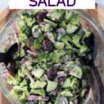 Tahini Broccoli Salad in a mixing bowl with salad tongs.