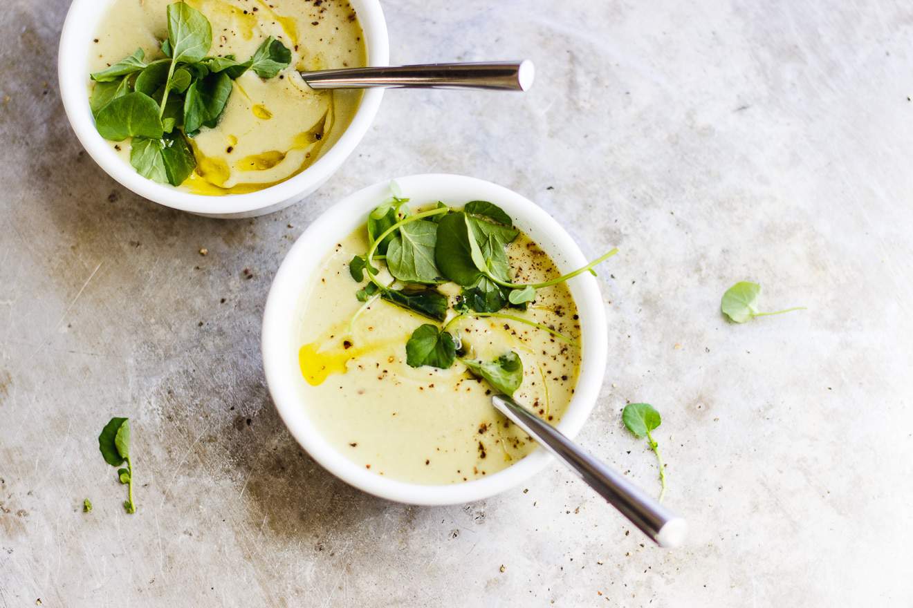 Spoon in a bowl of celery soup.