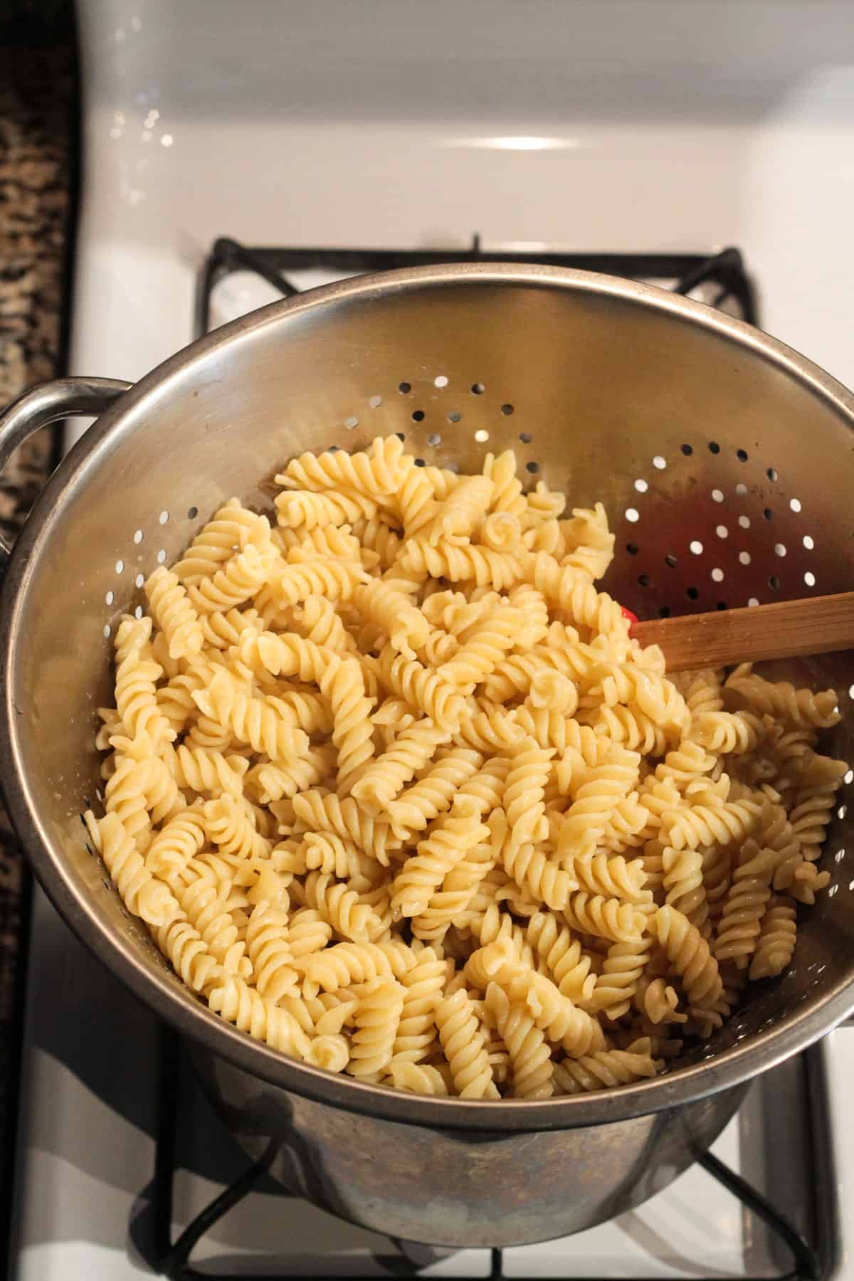 Draining cooked pasta in a colander.