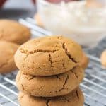 Stack of three pumpkin sugar cookies with crackly tops.