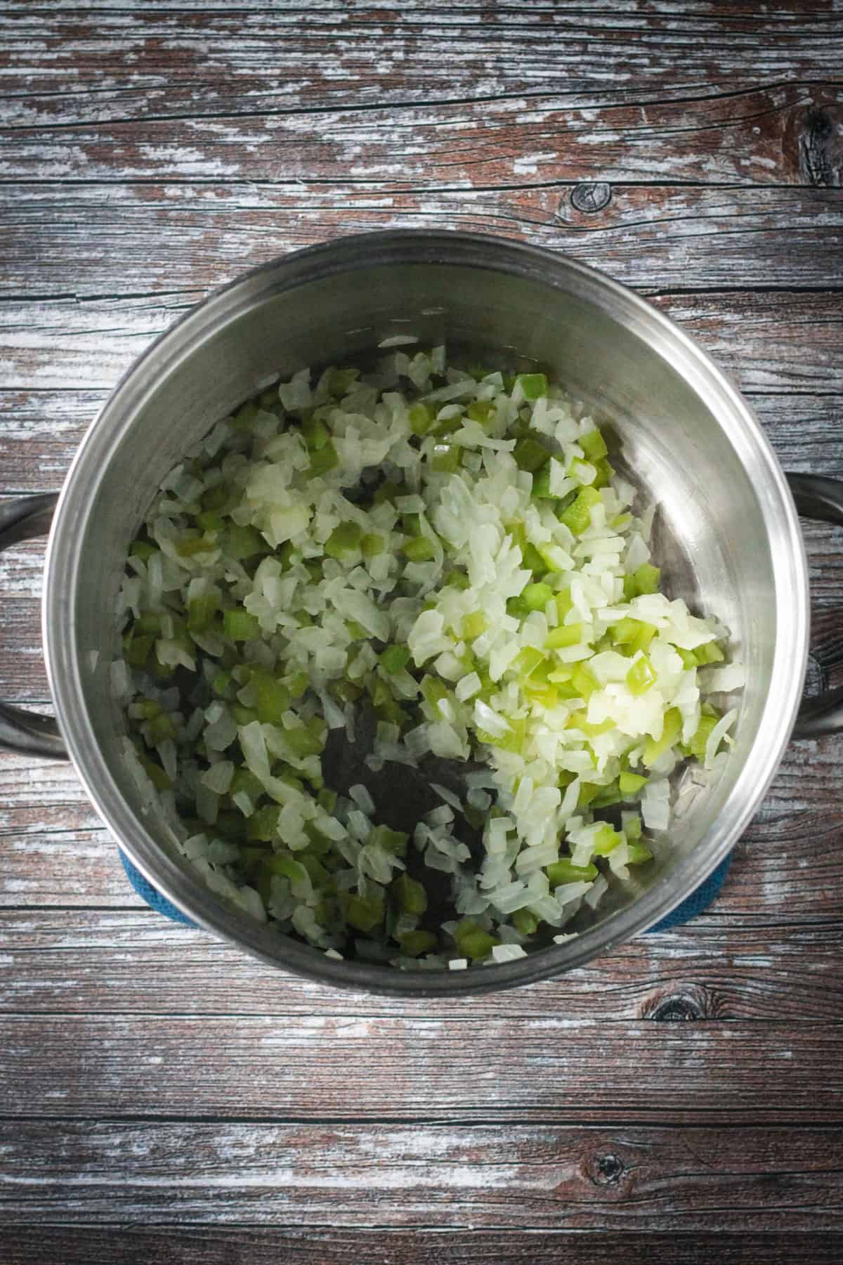 Sautéed onions and peppers in a soup pot.