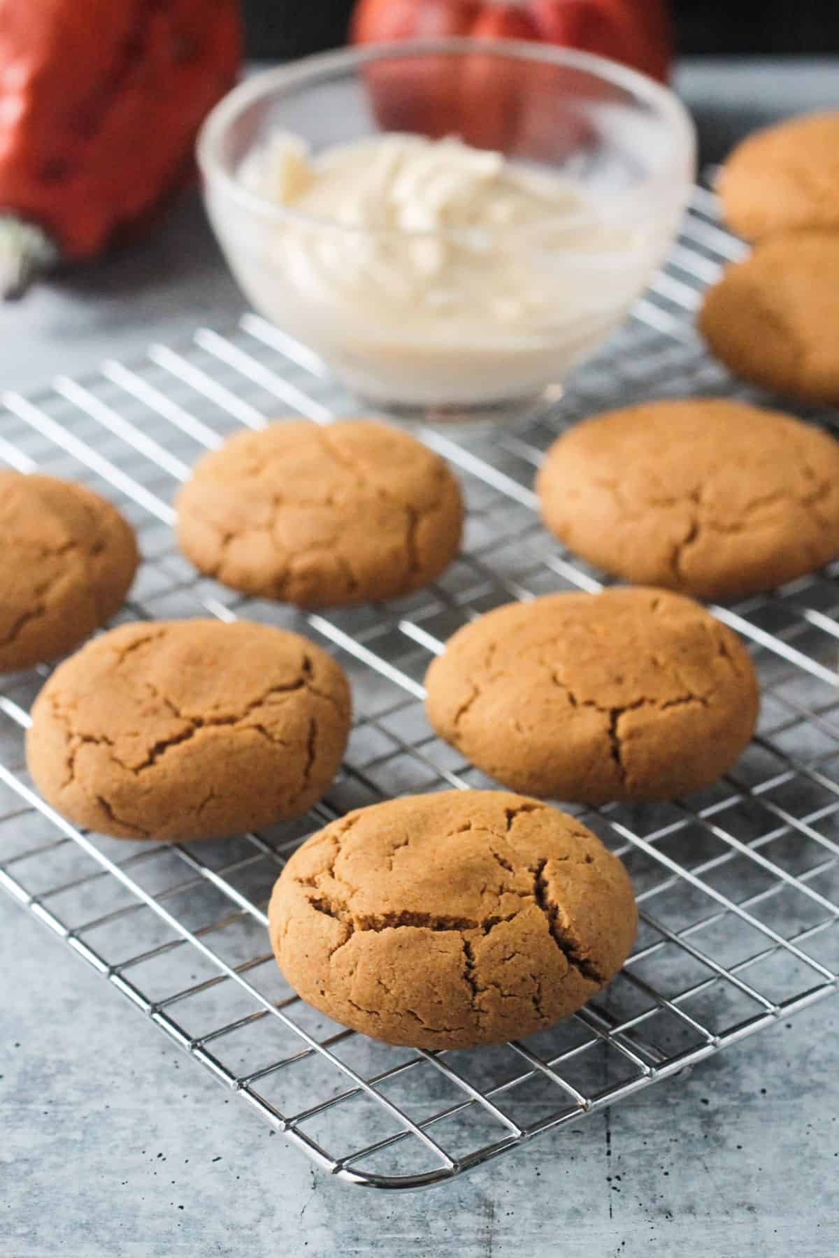 Baked pumpkin cookies on a cooling rack.