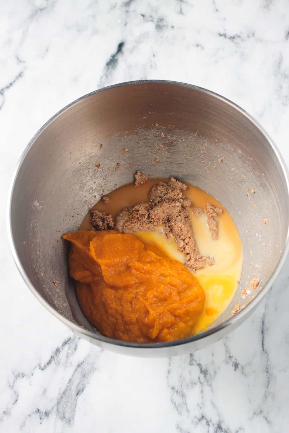 Pumpkin purée added to the bowl with butter and sugar.