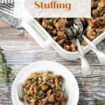 Serving of stuffing on a white plate in front of the baking dish.