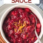Homemade cranberry sauce in a bowl with a spoon.