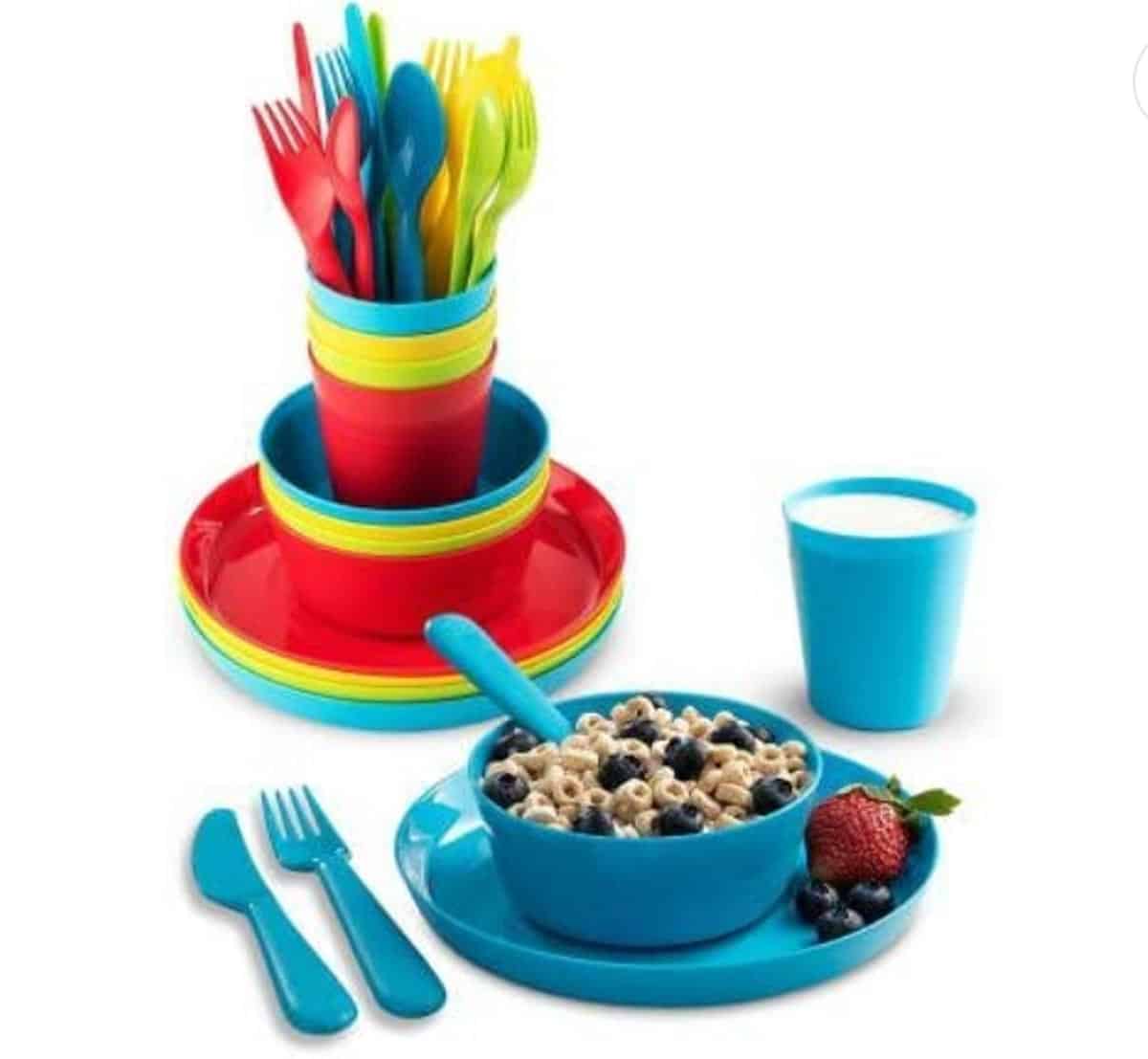 Set of kids bowls, plates, cups and utensils in a rainbow of colors.