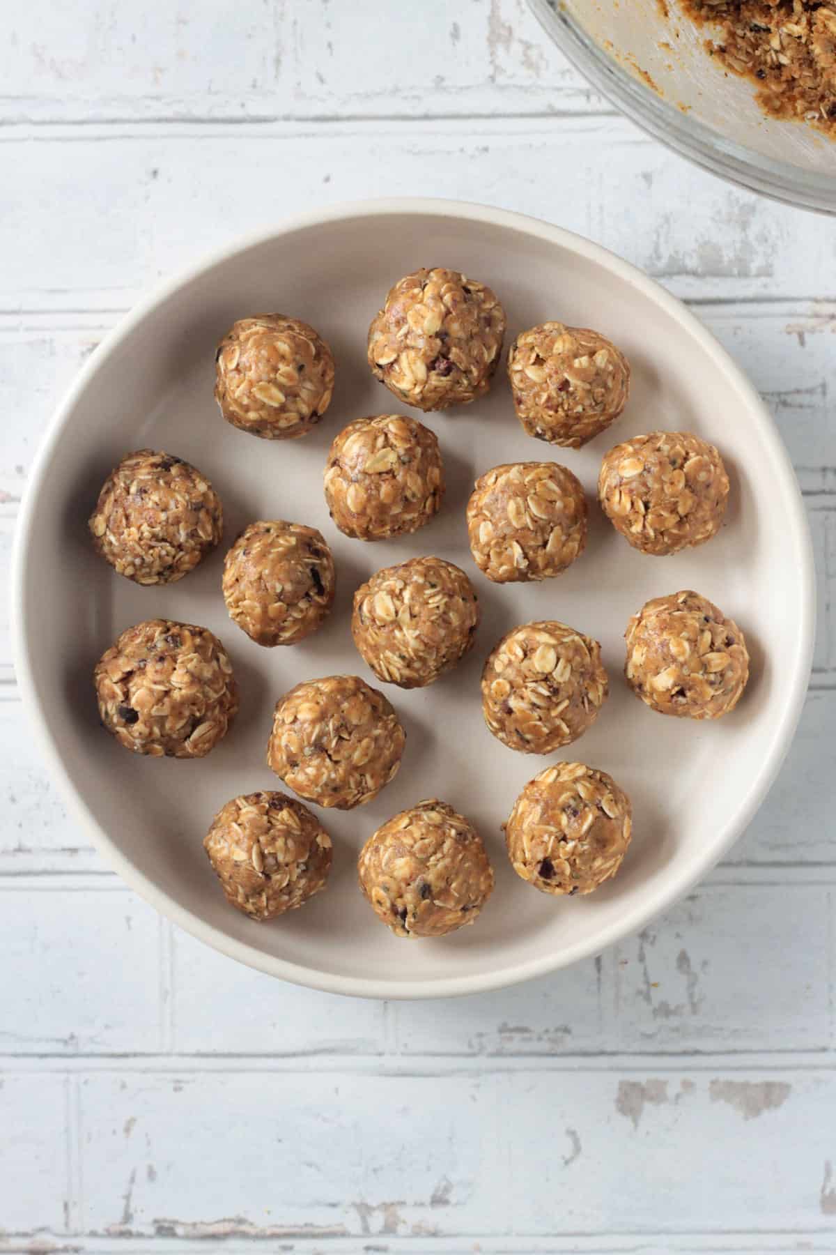 Oatmeal peanut butter balls arranged on a white plate.