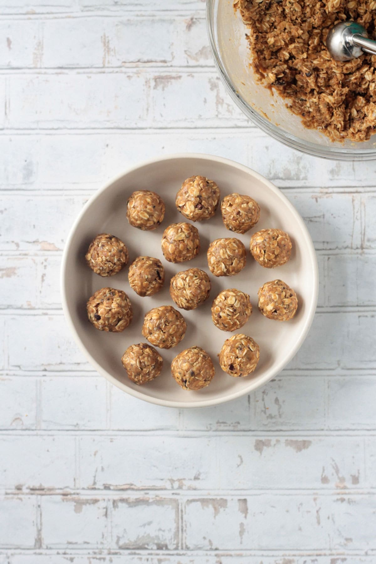 Peanut butter oatmeal balls spread out on a plate.