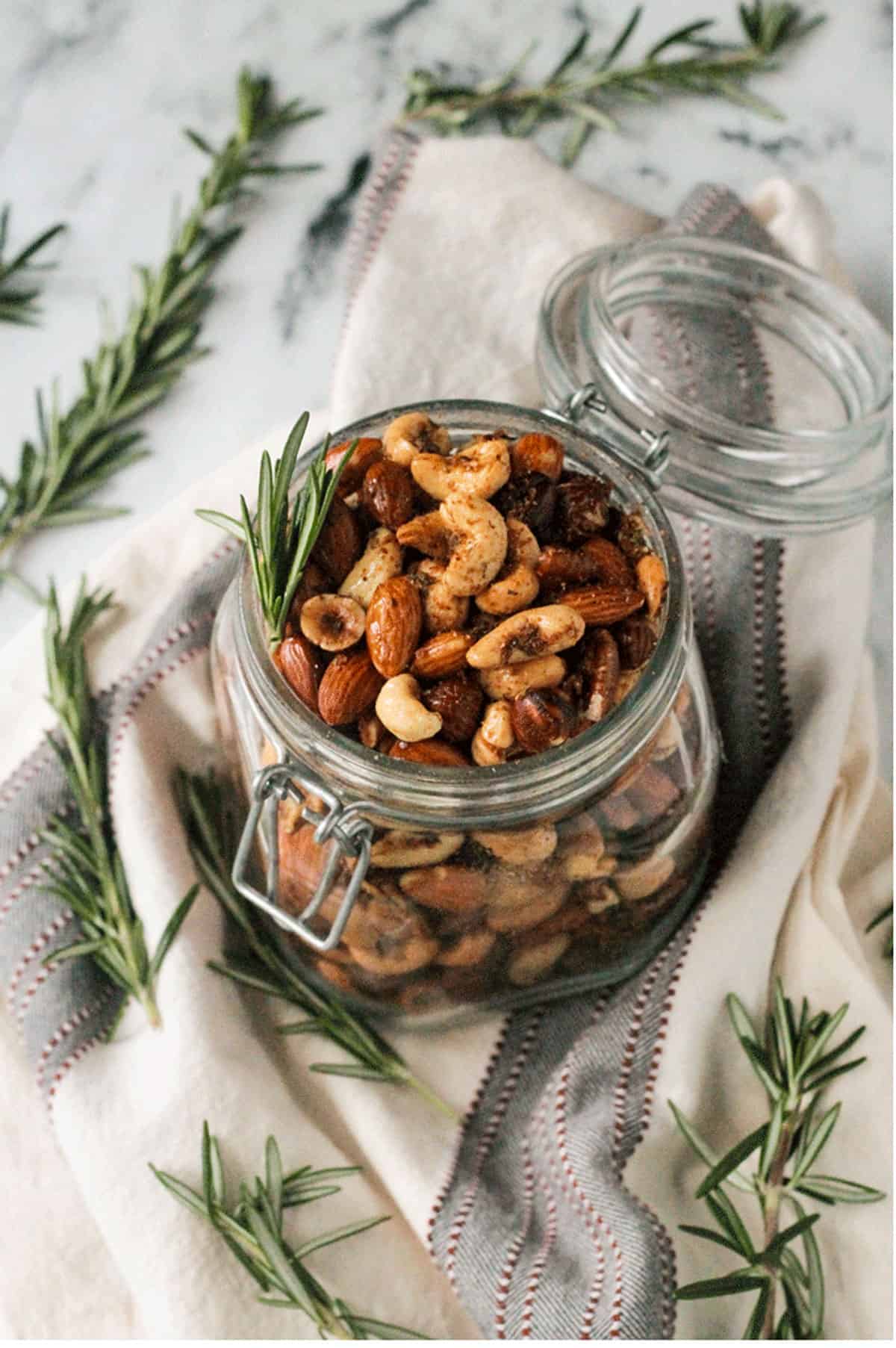 Overhead view of Spiced Roasted Nuts in an open mason jar.