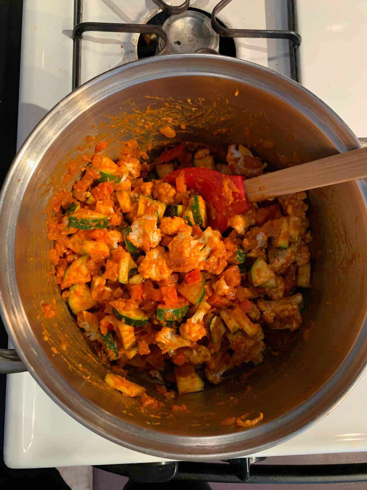 Sautéing the chopped vegetables in a soup pot.