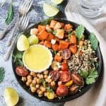 Three forks lie next to a Sweet Potato Quinoa Bowl with Cashew Curry Sauce.