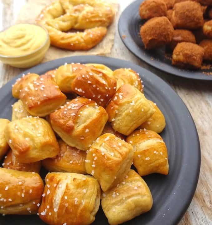 A pile of small bite size soft pretzel nuggets on a plate.