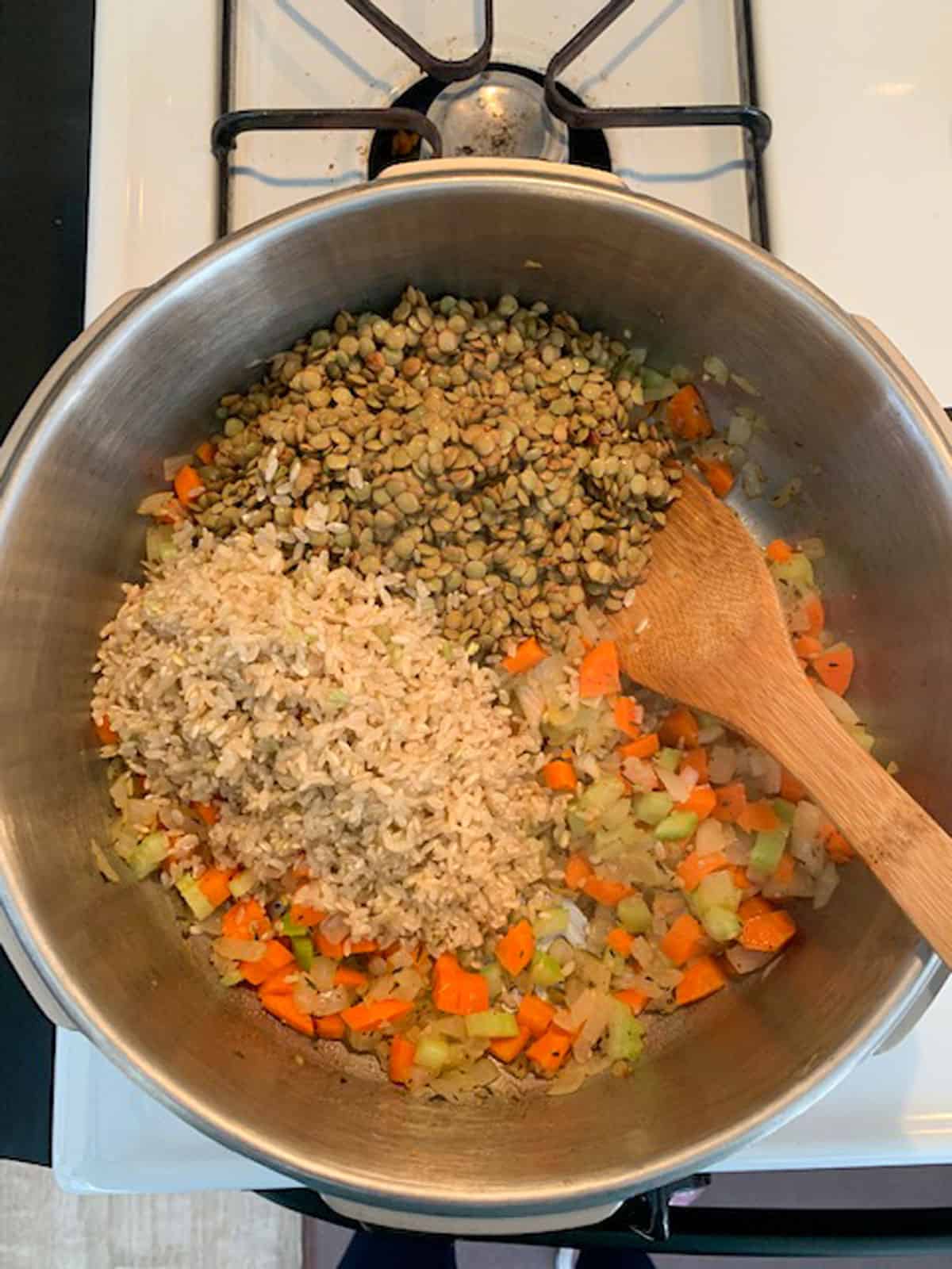 Adding rice and lentils to the pot.